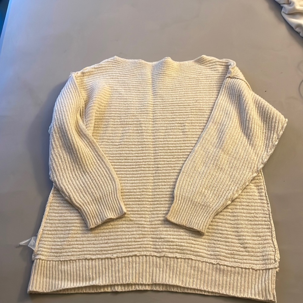 Cream colored oversized sweater.